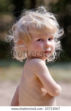 fine-art portrait of beautiful blonde little girl on nature background
