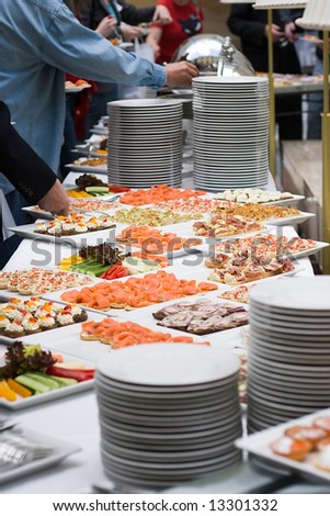 table with a lot of food for stand-up meal in a buffet