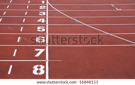 red running tracks with white start numbers at stadium closeup