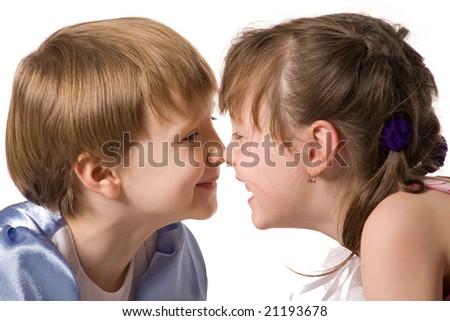 stock photo Two little girls sit face to face and smile isolated on white