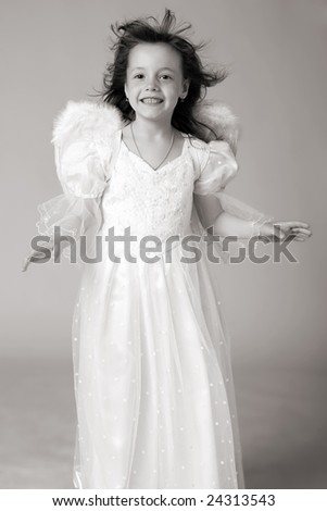 happy girl in white dress and angel wings