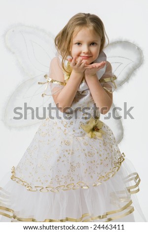 little girl in  beautiful dress with wings of the butterfly sends  air kiss, isolated on white