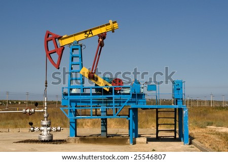 An industrial oil pump under a blue sky