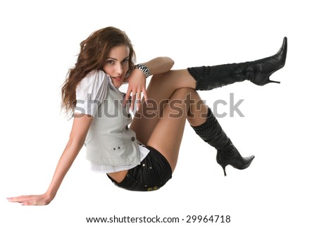 beautiful sexual girl lies on the floor and heaved up feet in knee-boots upstairs, isolated on white