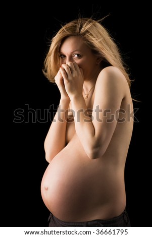 stock photo beautiful naked pregnant girl giggles on a black background