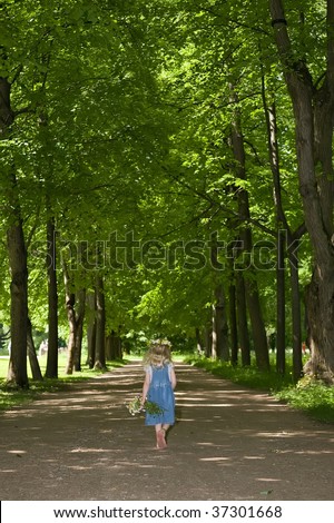 little girl is walking away along the path