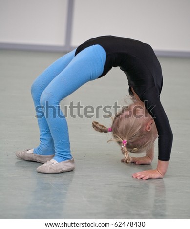 little gymnast girl on training in gym
