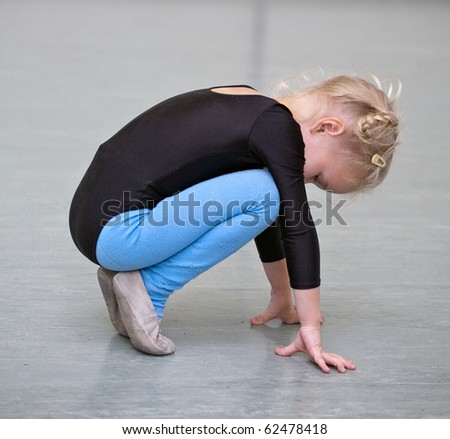 little gymnast girl doing exercises