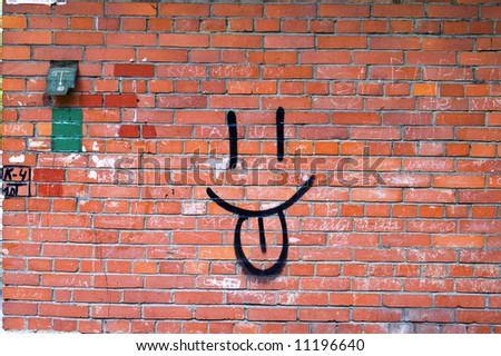 Smile Graffiti on Red Brick Wall.