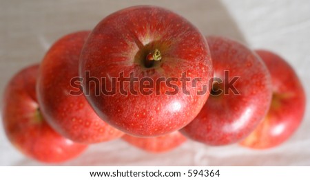 Six red apples stacked on top of each other seen from above