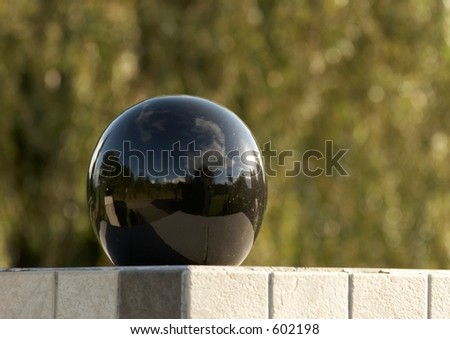 Black reflective ball used as fencepost