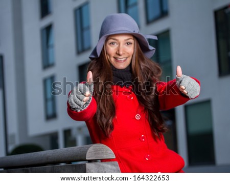 winter girl thumps up