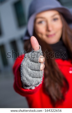 winter girl thumps up