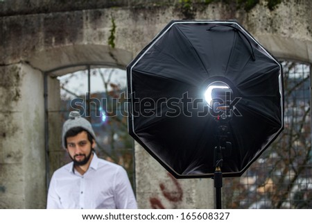 bearded man with photo flash unit