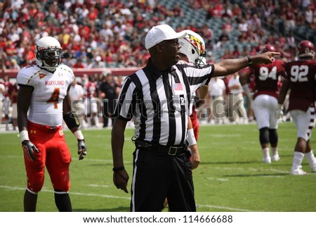 PHILADELPHIA, PA. - SEPTEMBER 8: The referee  signals a penalty against the defense during a game, Maryland against Temple on September 8, 2012 at Lincoln Financial Field in Philadelphia, PA.