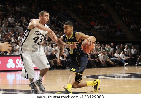  - stock-photo-university-park-pa-february-michigan-s-tim-hardaway-jr-dunks-against-penn-state-at-the-133129088