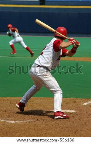 Baseball Batter waiting for his pitch, runner stealing second base in background
