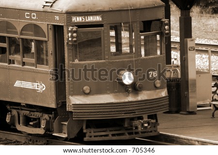 trolley car pulling into the station, sepia-toned