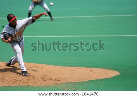 Pitcher, left-handed ball frozen in the air