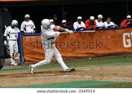 Baseball batter hitting the ball