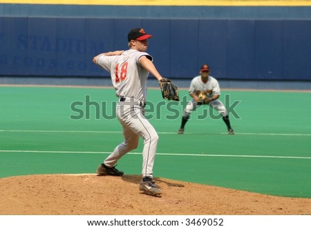 Baseball Pitcher, left-handed in mid wind-up