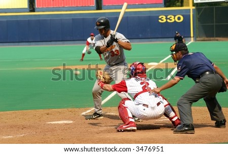 left-handed baseball  batter watching a pitch go by, Strike one,