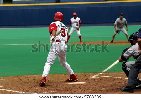 Right-handed baseball player watching his hit