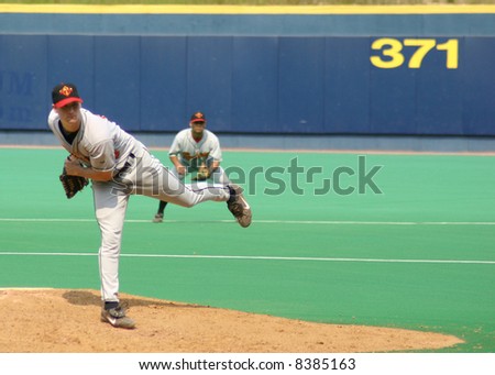Baseball Pitcher, left-handed following through on his delivery