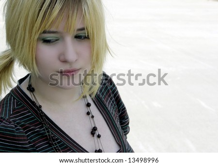 Young Lady with pony-tail  looking down with copy-space