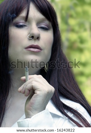 Beautiful redhead Woman smoking a cigarette, nose ring