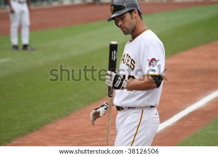 PITTSBURGH - SEPTEMBER 24 : Garrett Jones of the  Pittsburgh Pirates looks at his bat after striking out against Cincinnati Reds on September 24, 2009 in Pittsburgh, PA.