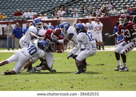 defenders tackle Temple wide out