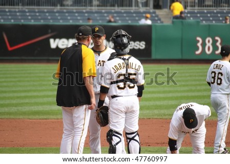 PITTSBURGH - SEPTEMBER 24: Pittsburgh Pirates\' pitching coach speaks with Charlie Morton during a game against Cincinnati Reds on September 24, 2009 in Pittsburgh, PA.