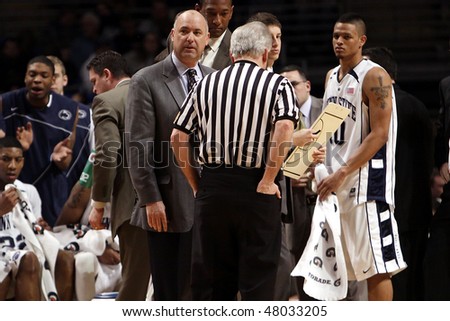 UNIVERSITY PARK, PA - FEBRUARY 24: Penn State\'s head coach, Ed DeChellis, in the gray suit,  speaks with a referee Byrce Jordan Center February 24, 2010 in University Park, PA