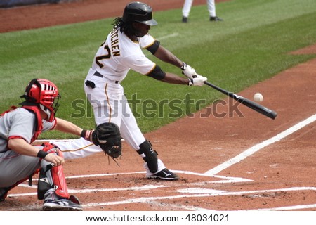PITTSBURGH - SEPTEMBER 24 : Andrew McCutchen of the Pittsburgh Pirates swings and connects on a pitch against  Cincinnati Reds on September 24, 2009 in Pittsburgh, Pa.