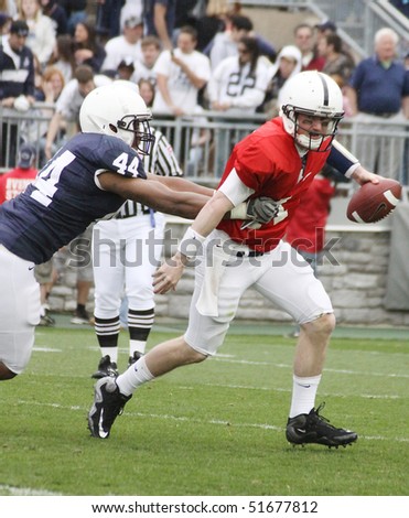 UNIVERSITY PARK, PA - APRIL 24: Penn State quarterback Matt McGloin #11 tries to escape a tackle at Beaver Stadium April 24, 2010 in University Park, PA