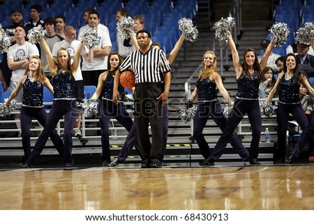 UNIVERSITY PARK, PA - JANUARY 5: Members of the Penn State dance team preform as the referee stands still in the center at the Byrce Jordan Center January 5, 2011 in University Park, PA