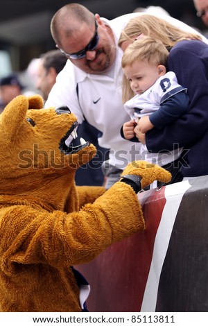 PHILADELPHIA, PA. - SEPTEMBER 17: Penn State mascot the Nittany Lion makes friends with a little boy during a game against Temple on September 17, 2011 at Lincoln Financial Field in Philadelphia, PA.