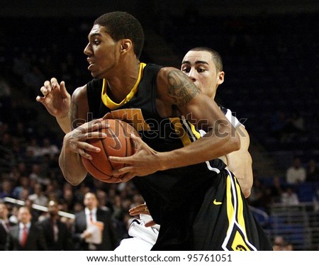 UNIVERSITY PARK, PA - FEB 16: Iowa's Roy Devyn Marble is defended by Penn State's Ross Travis during a game at the Byrce Jordan Center on February 16, 2012 in University Park, PA