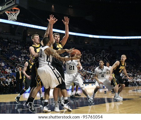 UNIVERSITY PARK, PA - FEB 16: Iowa\'s defense collapses on Penn State\'s Jermaine Marshall as he passes the ball during a game at the Byrce Jordan Center on February 16, 2012 in University Park, PA