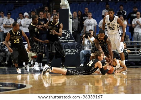 UNIVERSITY PARK, PA - JANUARY 5: Purdue and Penn State players scramble for a loose basketball at the Byrce Jordan Center on January 5, 2011 in University Park, PA