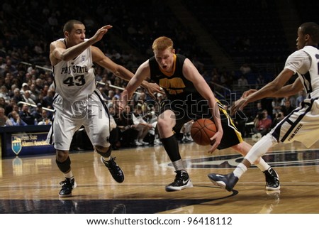 UNIVERSITY PARK, PA - FEB 16: Iowa\'s Aaron White drives to the basket defended by Ross Travis  during a game against Penn State at the Byrce Jordan Center on February 16, 2012 in University Park, PA