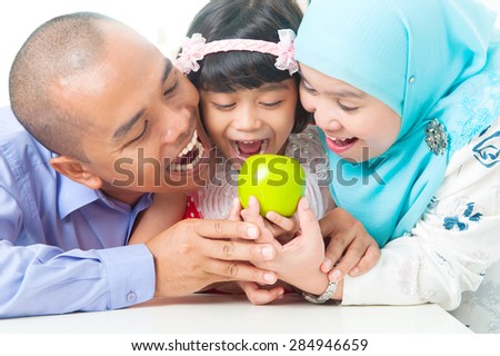 Malay family eating apple