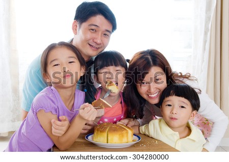 Asian family eating home baked cakes