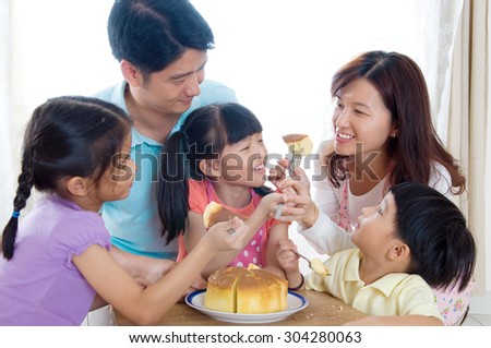 Asian family eating home baked cakes