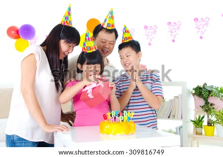 Asian family enjoying birthday party at home