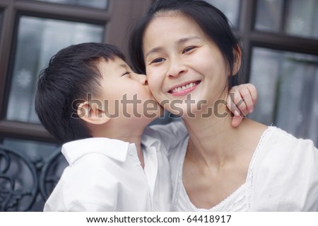 asian boy kissing his mum