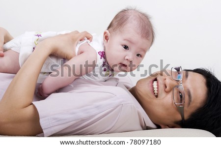 Asian family. Asian father playing with his baby girl
