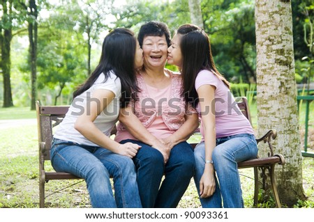 daughters kissing mother
