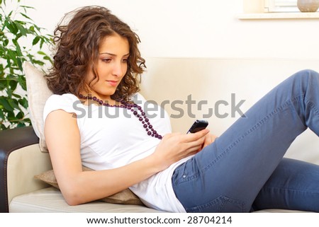 casual woman on a couch using a phone